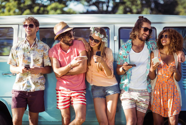 group of people on a summer day using their phones.